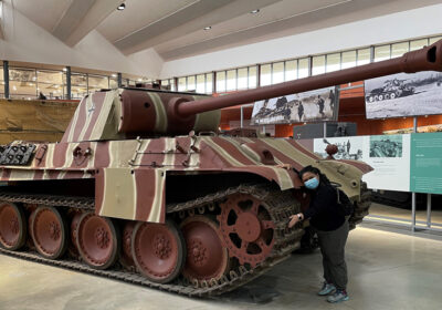 Bake Off winner Syabira Yusoff hugging a Panther at the Tank Museum in Bovington