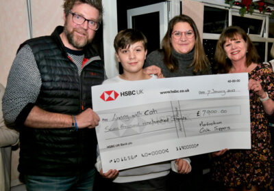 Brewers Arms, Martinstown, owners Leanne and Ben Carter with one of their sons and Roelie Newman, from Martinstown Circle Suppers, holding the cheque for £7,000 raised for Living with CAH.