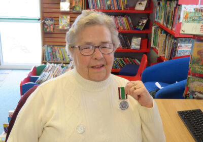 Eileen Osgood shows off her Long Service Medal