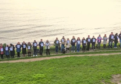 30 representatives of the Homelessness Partnership BCP at Bournemouth beach, each representing five children spending Christmas in B&Bs