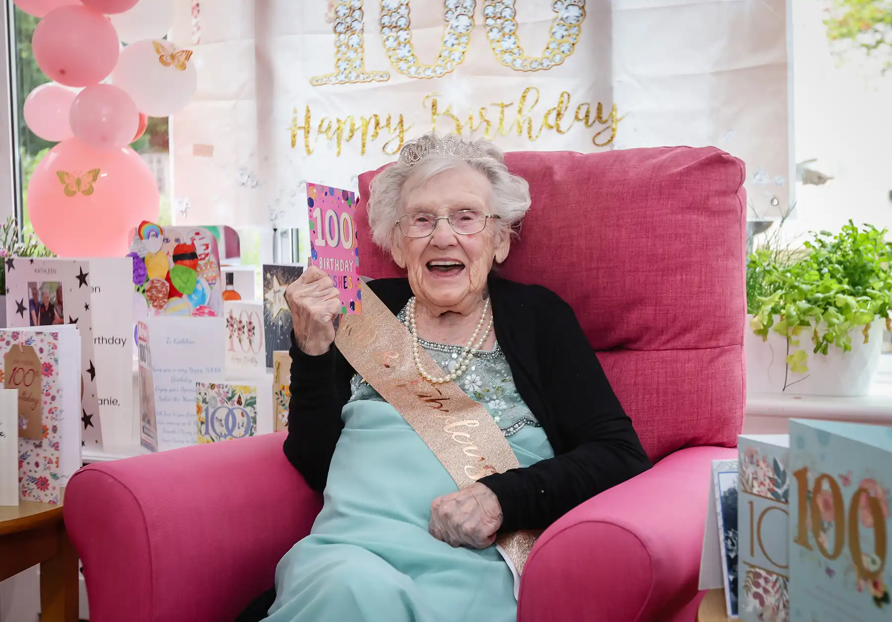 Kathleen surrounded by some of the 400-plus cards she received in Poole