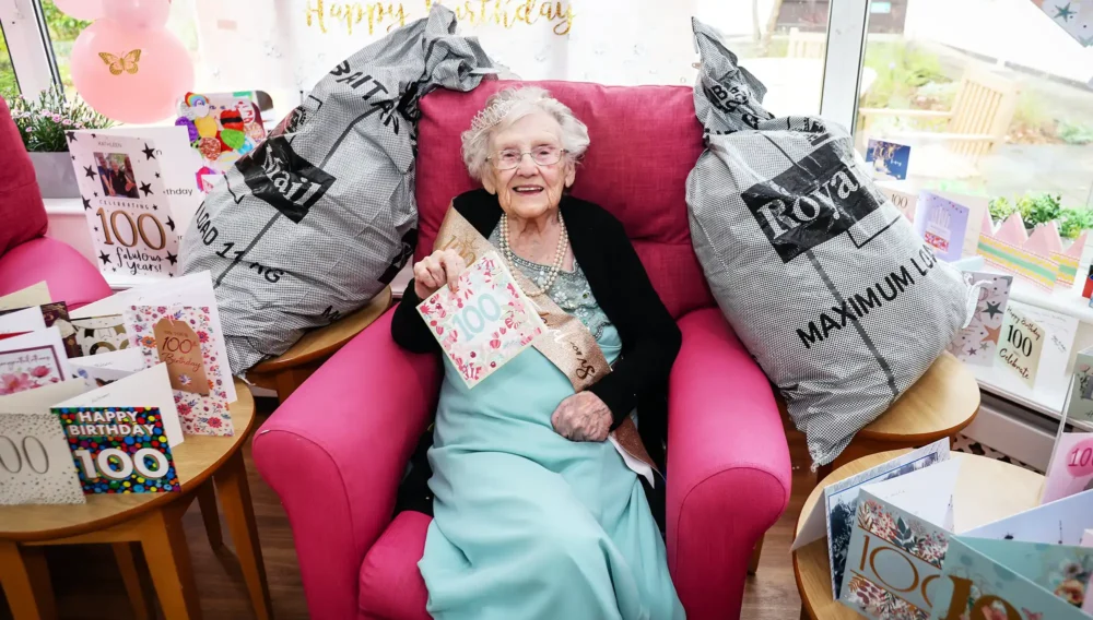 Kathleen surrounded by some of the 400-plus cards she received in Poole