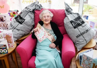 Kathleen surrounded by some of the 400-plus cards she received in Poole