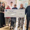 The team and residents handing the cheque to PAALS Picture: Care South